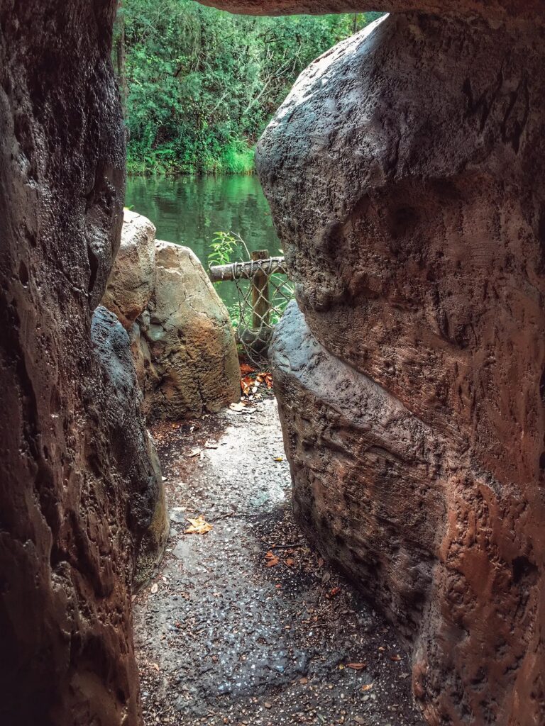 almost out of the cave with walt disney's initials carved on tom sawyer island at magic kingdom